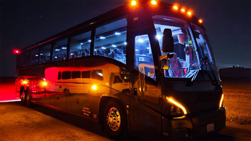 MLA Charters luxury coach bus at night